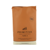 Brown bag with 'Primitiva' branding on a white background
