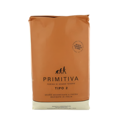 Brown bag with 'Primitiva' branding on a white background